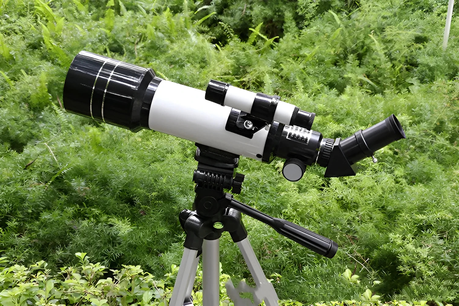 Dark blue children's astronomical telescope with monocular eyepiece on a tripod.