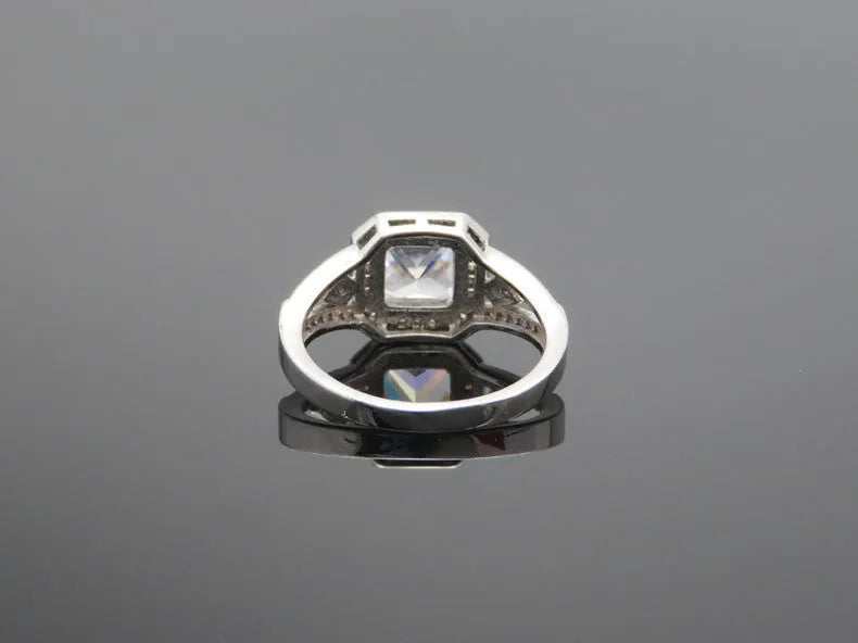 Women's geometric ring with hollow design and inlaid zircon stone in platinum colour.