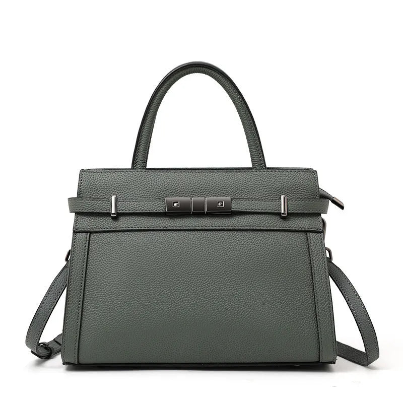 A structured square genuine leather women's crossbody bag in black, shown open to reveal internal organiser pockets.