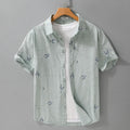 Loose fit pure cotton short sleeve shirt in light green, shown on a model.
