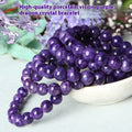 Natural transparent charoite hands design bead bracelet with platinum setting on a wrist.