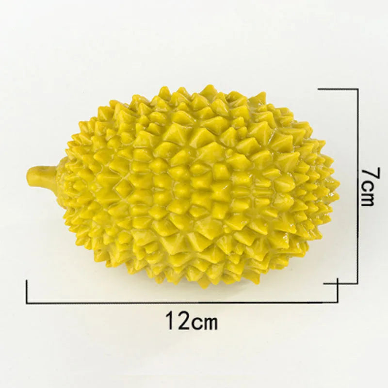 Beige, green, and yellow durian-shaped dog chew toy with raised bristles for teeth cleaning.