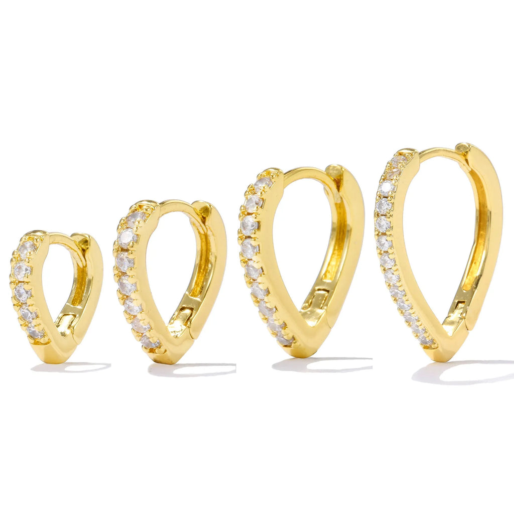 Geometric gold-coloured heart-shaped ear clip on a white background.