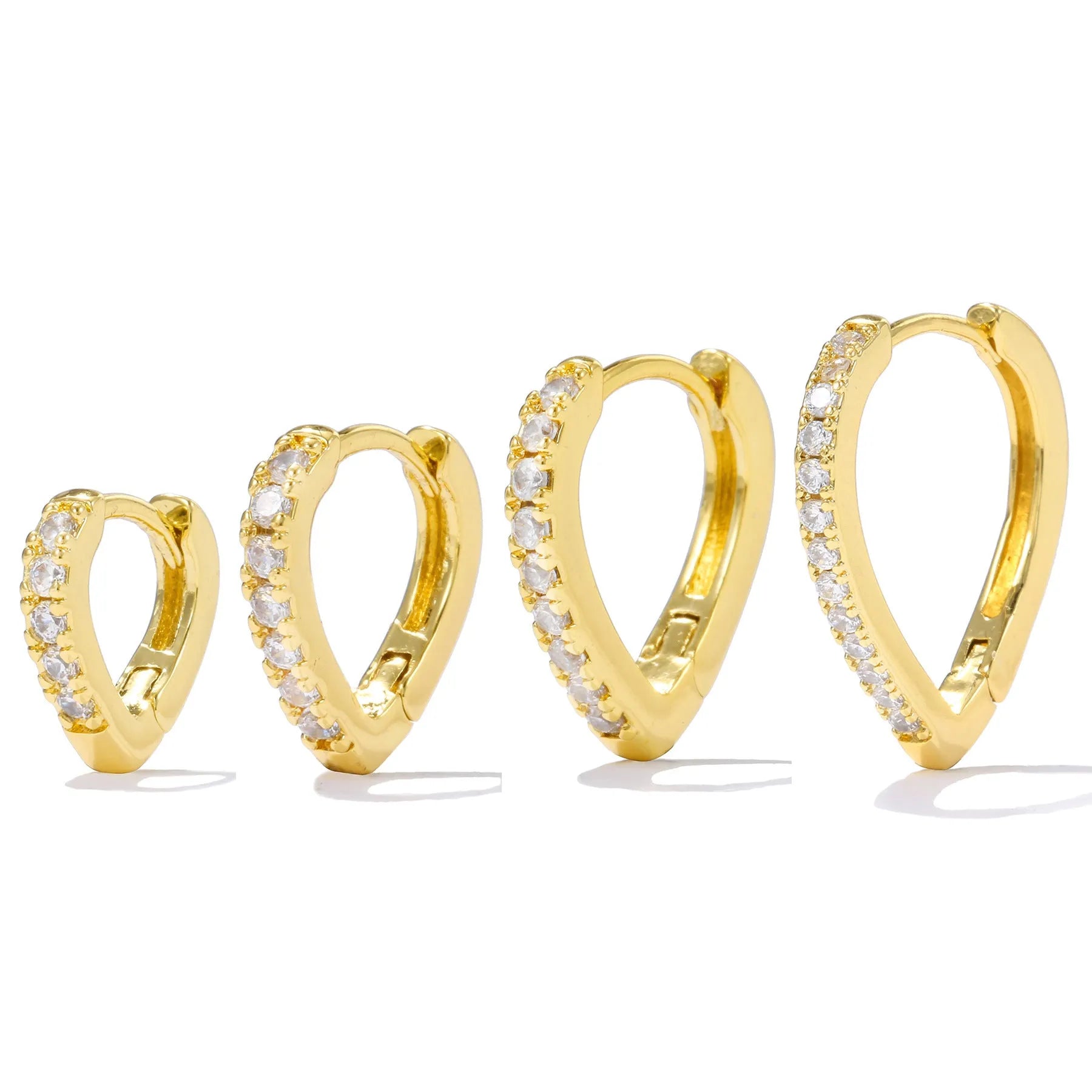 Geometric gold-coloured heart-shaped ear clip on a white background.