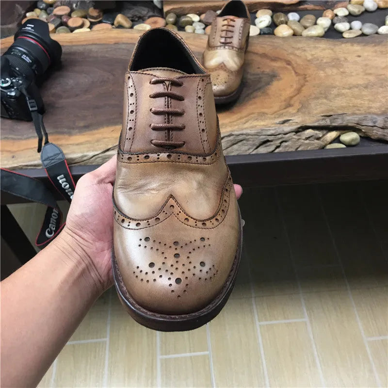Men's light brown distressed leather lace-up shoes with hand-carved vintage detailing