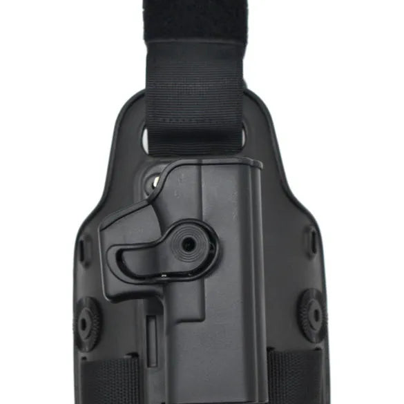 Black tactical plastic leg holster with quick-pull flap and MOLLE webbing on a belt.