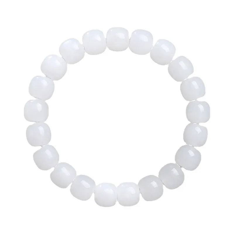 Handmade white Hetian jade barrel bead bracelet for men and women on a wrist.