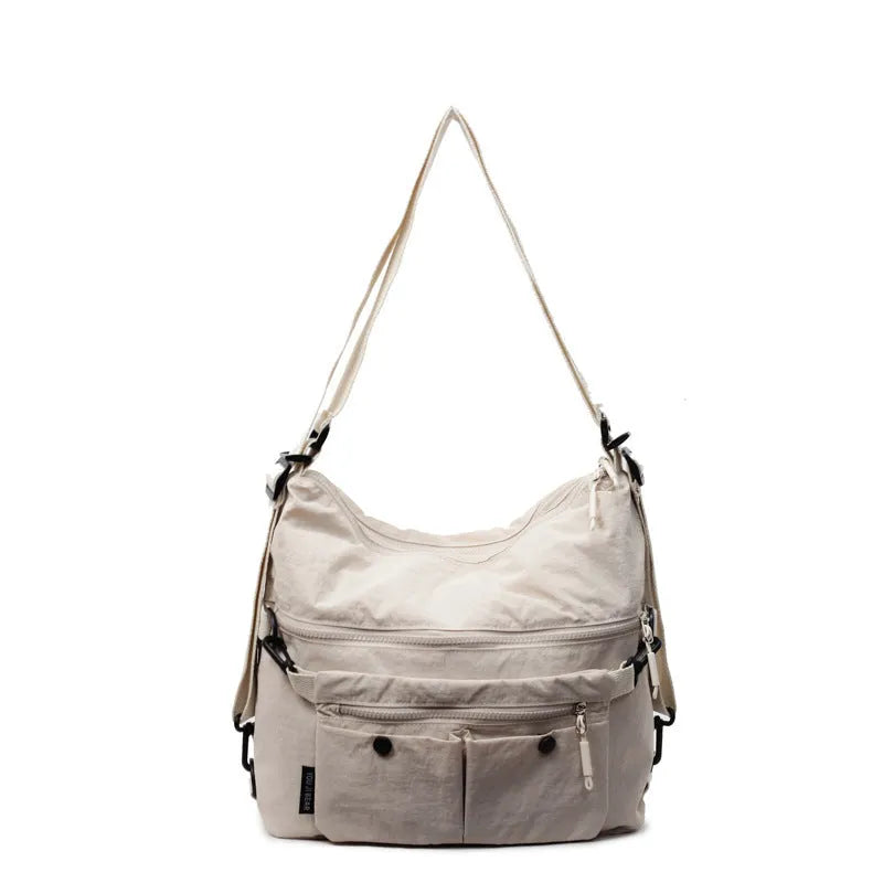 Women's nylon crossbody bag with double shoulder straps showing multiple pockets in black colour