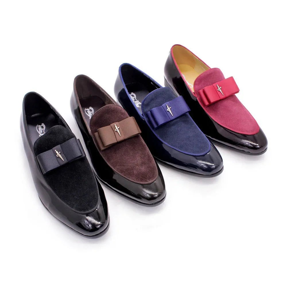 Men's black patent leather shoes with a gold tassel detail on a rubber sole.
