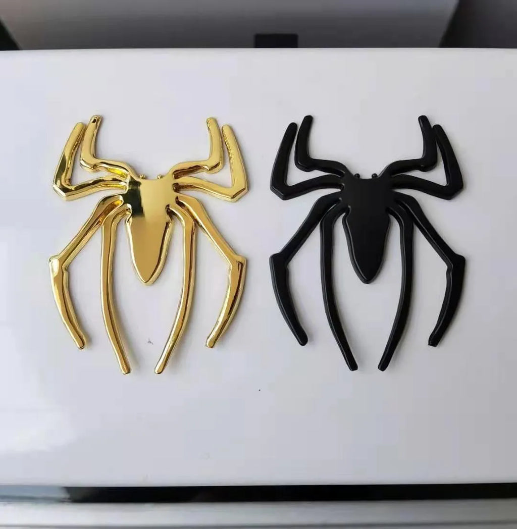 Three-dimensional metal spider bumper sticker in zinc alloy, showing gold, silver, black, and red colour options.