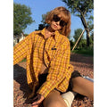 Dopamine yellow plaid shirt with a loose, cardigan-style fit on a hanger.