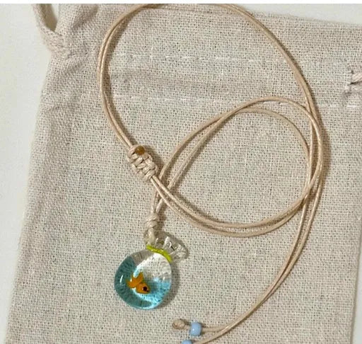 Women's necklace with coloured glaze joker charm on a cotton and linen clavicle chain