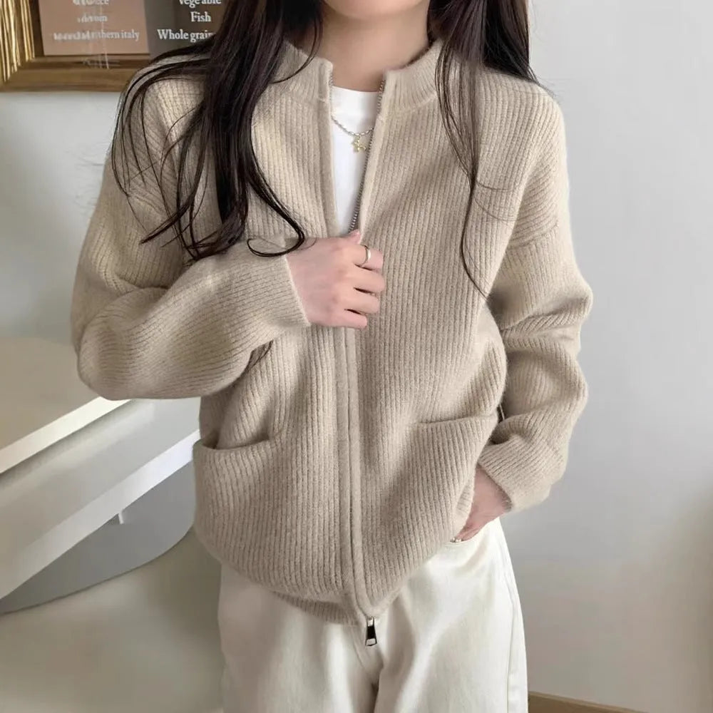 Beige viscose sweater coat cardigan with long sleeves on a hanger.