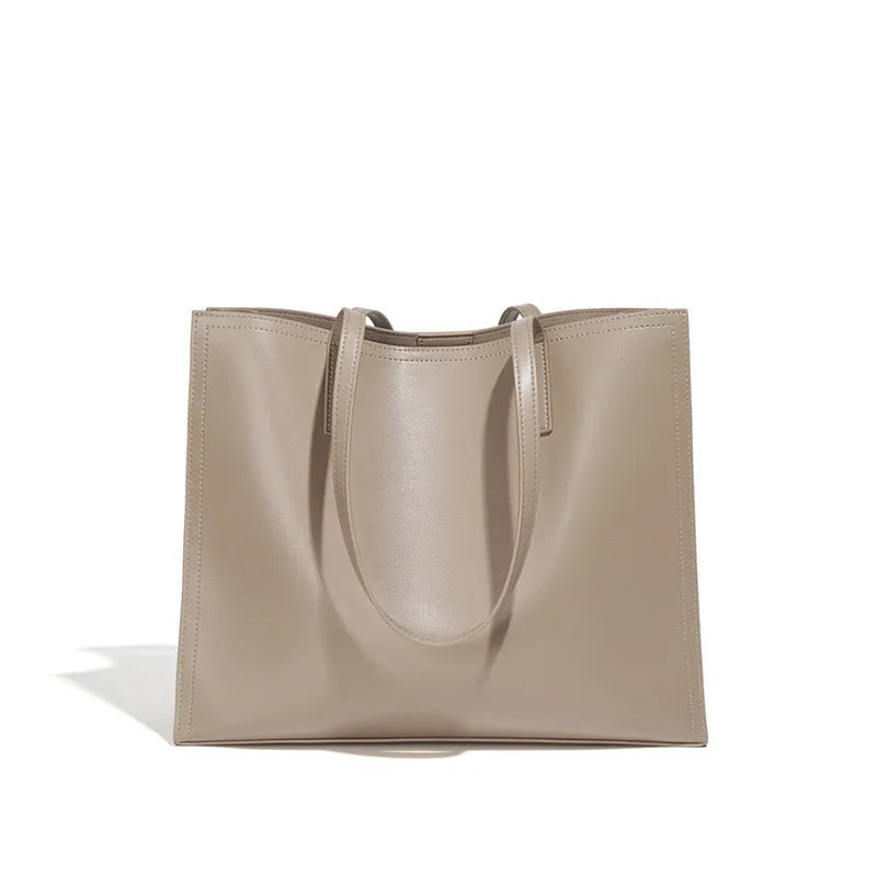 Brown genuine leather one shoulder handbag showing horizontal square shape and single strap.