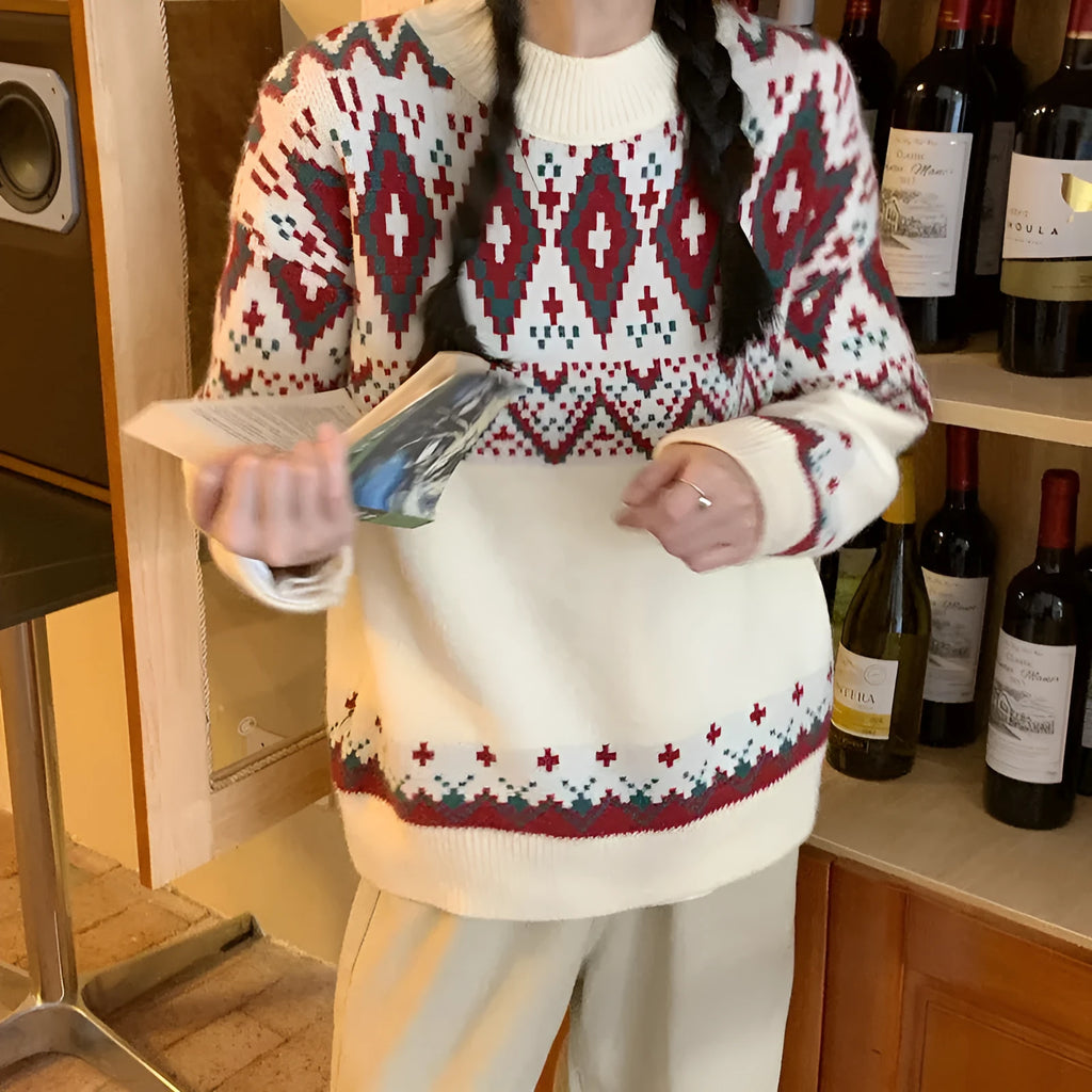 Red and white striped women's loose long-sleeve pullover knitted top on a hanger.