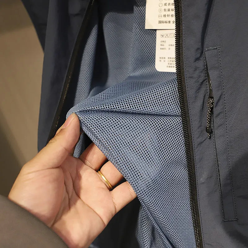 Men's solid colour nylon vest with side pockets in a straight, cardigan-style cut.
