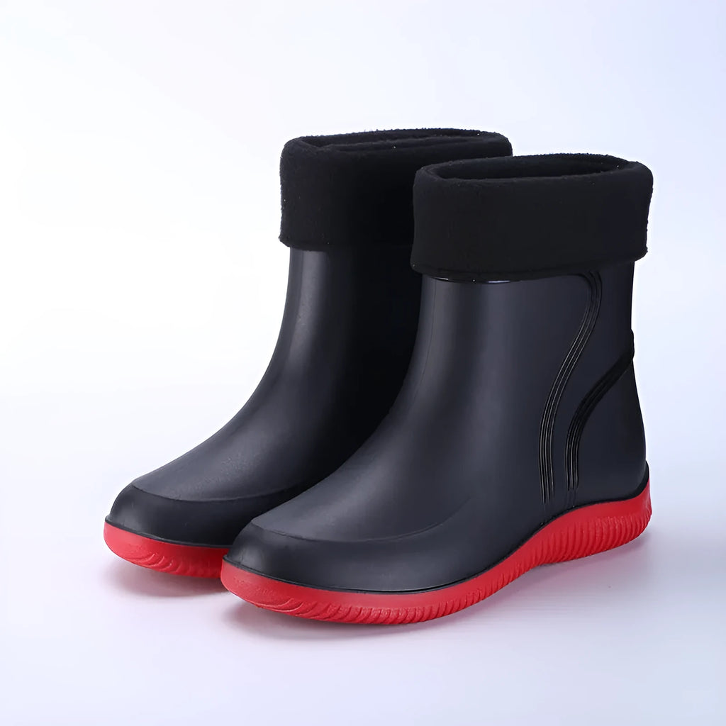 Men's mid-top PVC rain boots in black with green detailing, tassel decoration, and non-slip sole