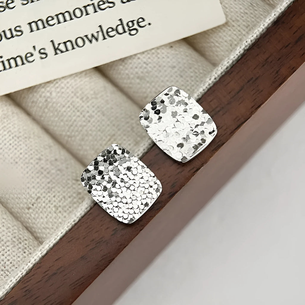 Pair of crushed ice square 925 silver stud earrings with white gold colour finish and geometric carved surface