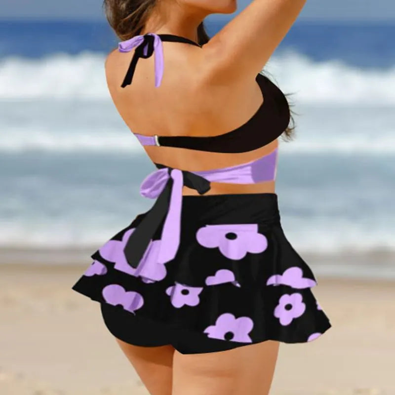 Women's purple split bikini set with high-waisted briefs and matching skirt for swimming
