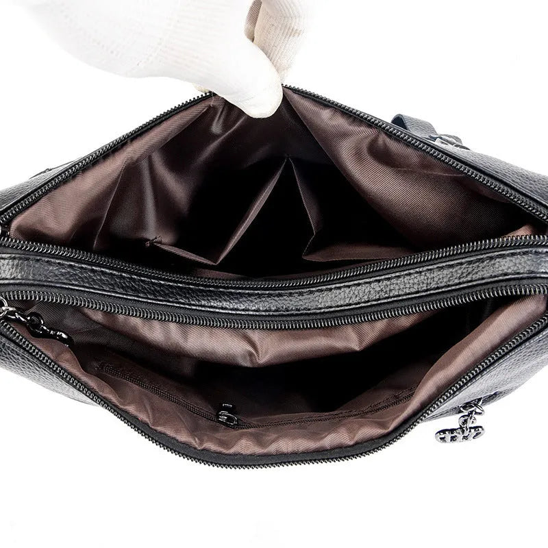 Genuine leather shoulder messenger bag in horizontal square shape with multiple internal compartments and single strap
