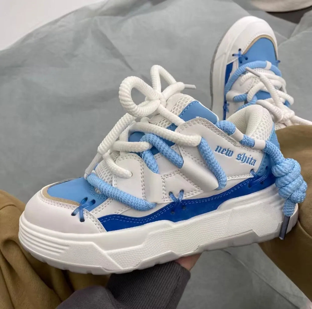 Women's thick sole grey retro sneakers with lace-up front and chunky rubber heel.