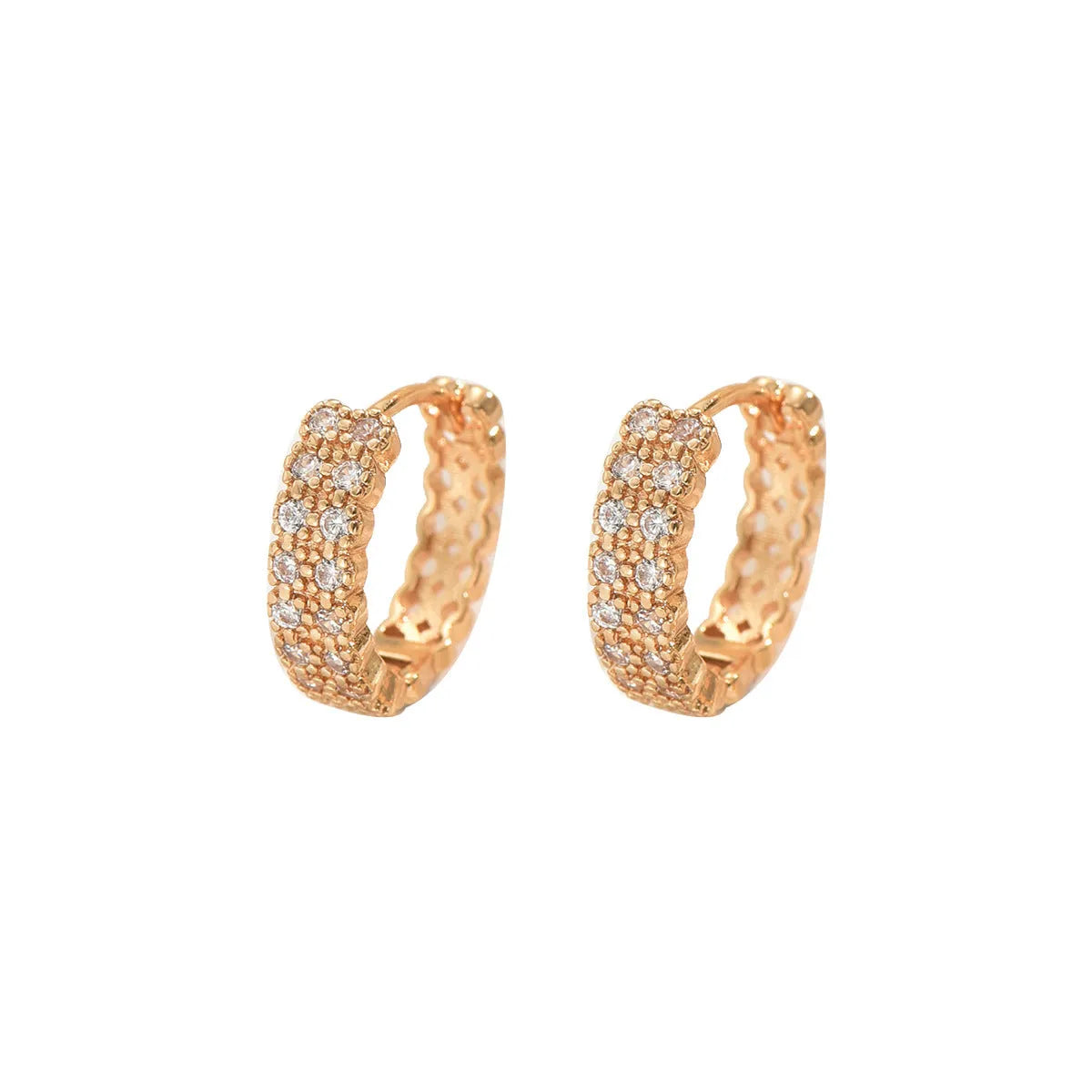 A pair of copper geometry pattern ear studs with round, dot, and ring design elements.