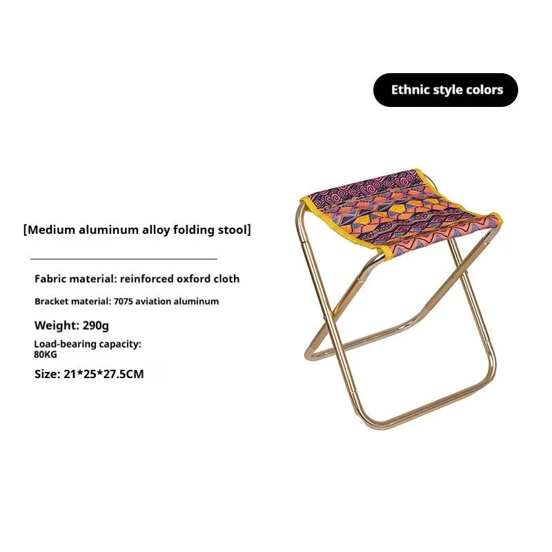 Black aluminium alloy folding camp stool in the open seating position.