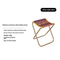 Black aluminium alloy folding camp stool in the open seating position.