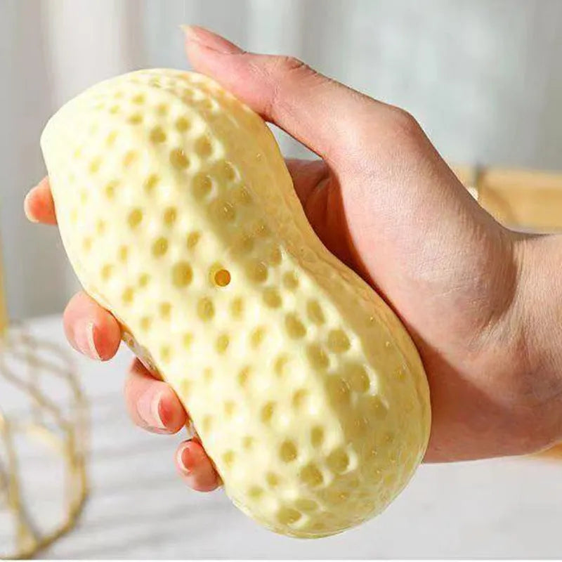 Yellow peanut-shaped dog chew toy with textured surface for dental cleaning