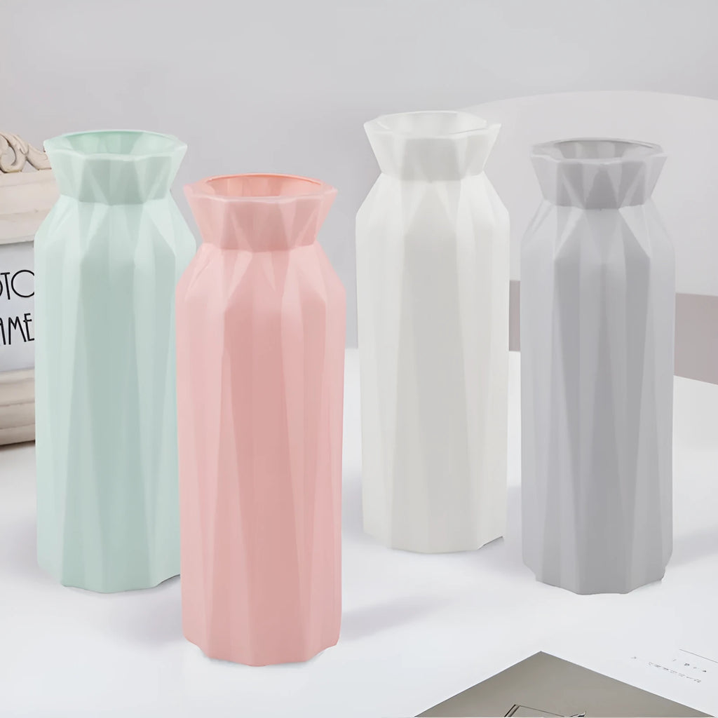 A green drop-resistant plastic melamine vase with a wide 7.2cm base on a wooden table.