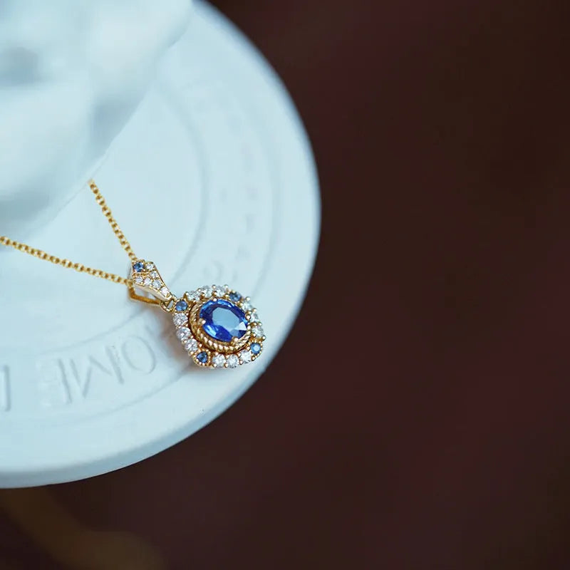 Golden copper necklace with a mixed gemstone inlaid pendant on a box chain.
