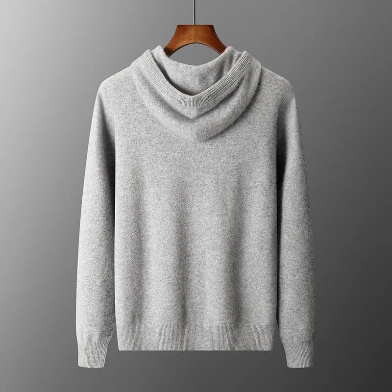 Man wearing a light grey cashmere hooded sweatshirt and matching trousers, a casual winter two-piece set.
