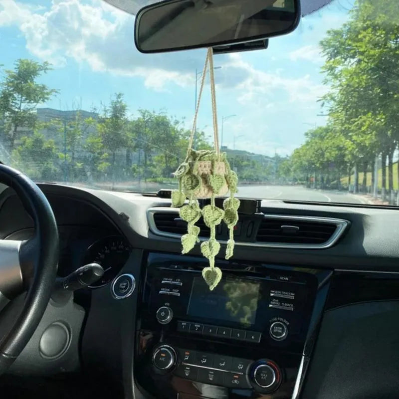 Green and white knitted wool car plant decoration with 8cm base and hanging rope.