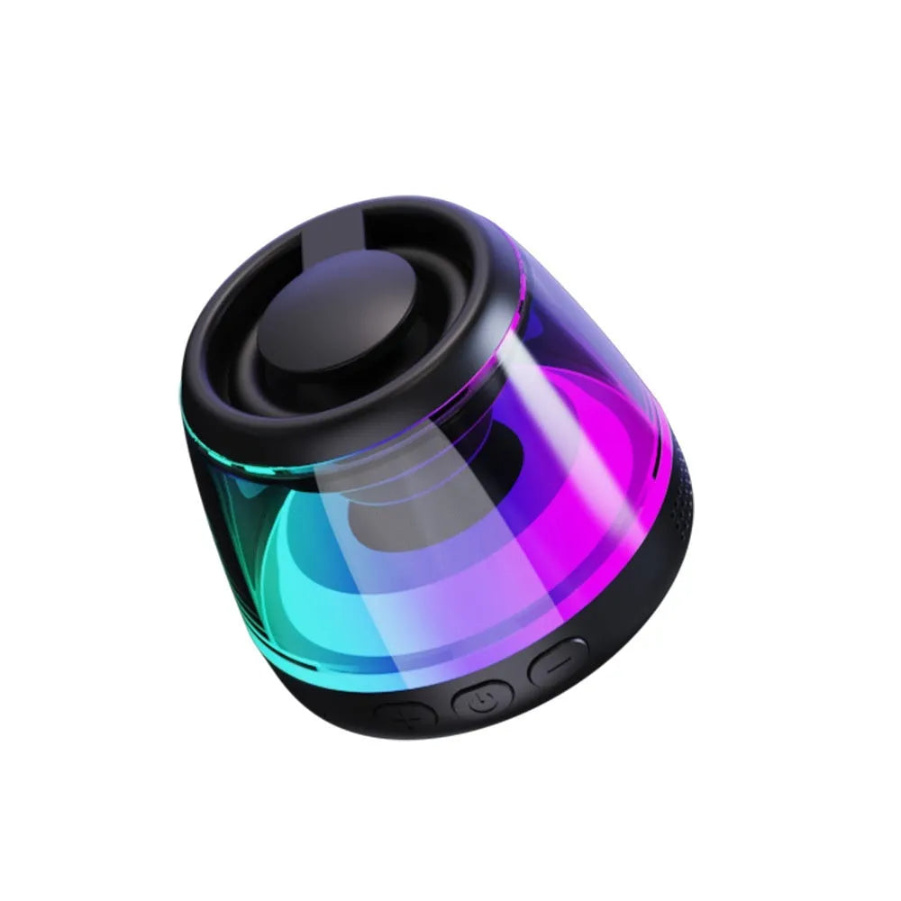 Black portable Bluetooth mini speaker with ambient light on a metallic surface, showing its magnetic base.