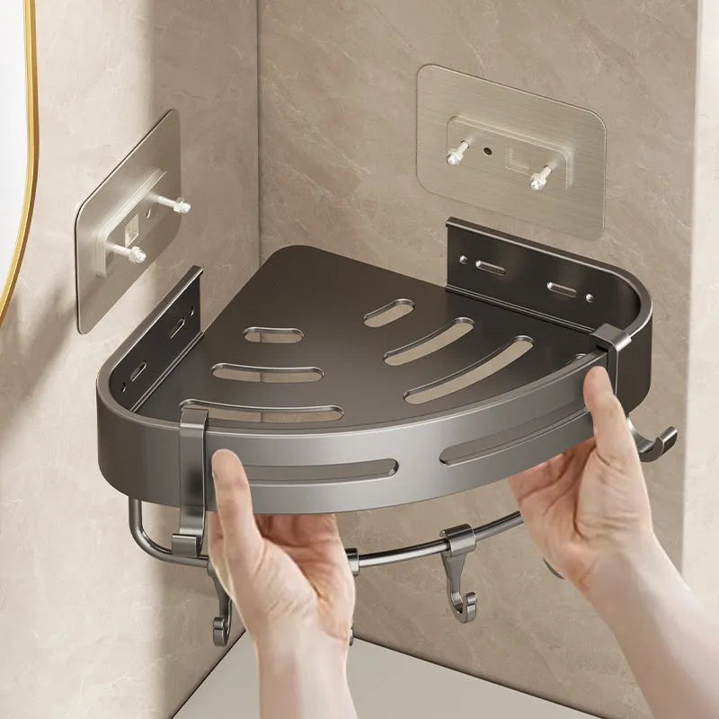 Gun grey punch-free bathroom corner storage rack with triangle basket mounted on wall.
