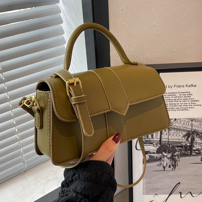 Beige women's square messenger bag with a top handle and shoulder strap, showing an outer pocket.