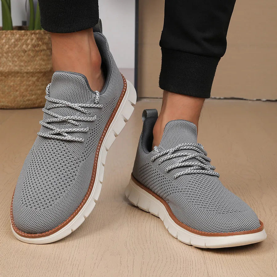 Men's grey and black casual sneakers with woven mesh upper and round toe.
