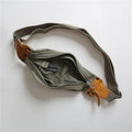 Green American retro military-style chest bag made of washed canvas with Italian leather accents
