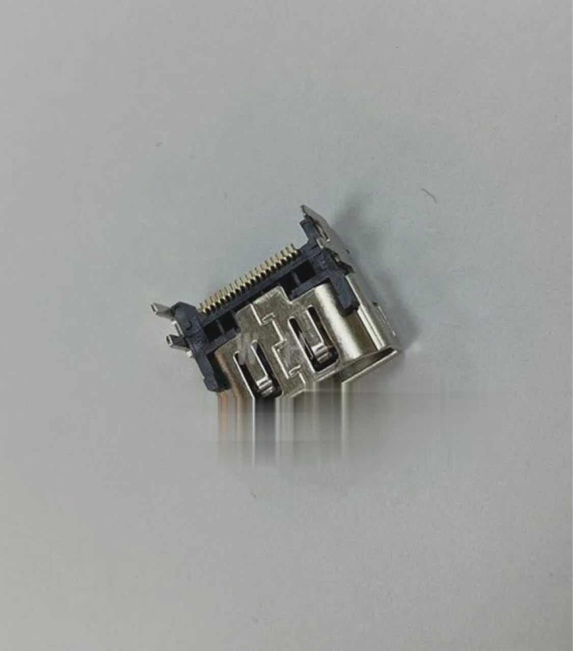 Silver HDMI host interface socket for game console repair and signal connectivity.