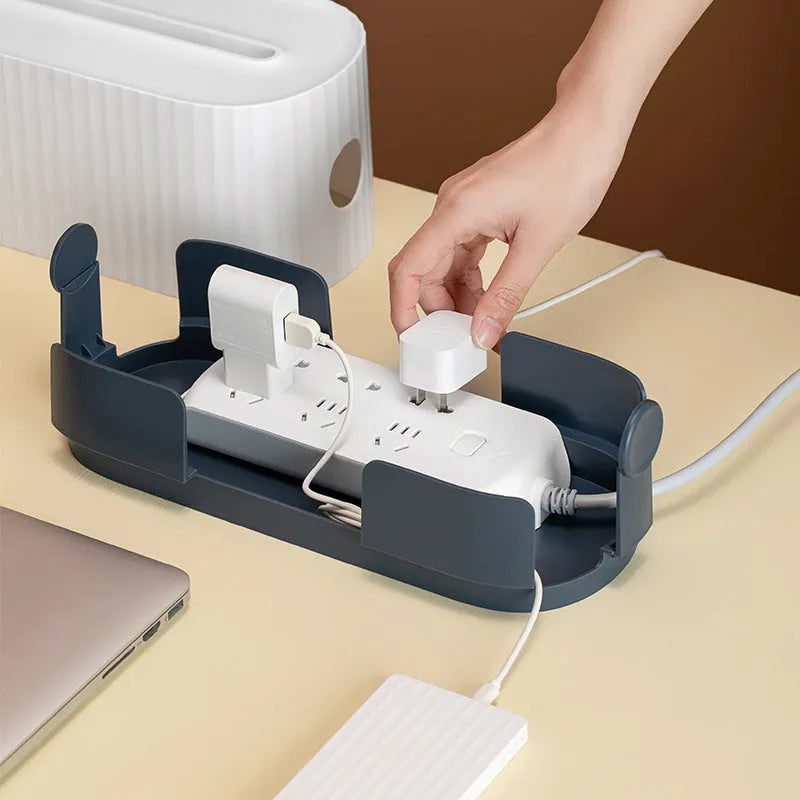 Blue and white power strip storage box with lid open showing cable holes and phone slot.