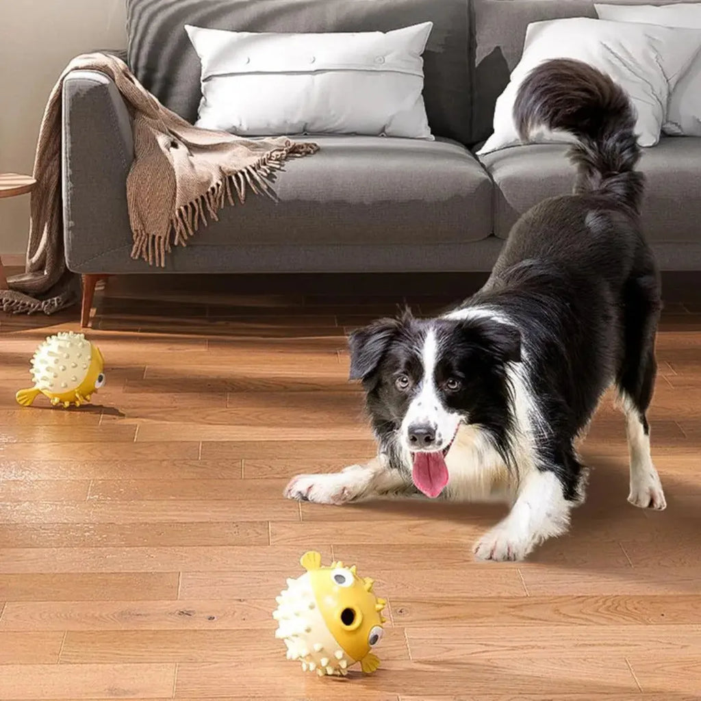 Yellow durable fish-shaped vinyl dog chew toy with textured surface and squeaker.
