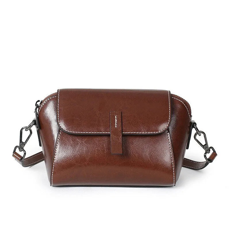Brown genuine oil wax leather women's messenger bag with crossbody strap and sewing line detail.