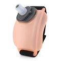Orange wrist-mounted water bottle with Velcro strap shown on wrist during running activity