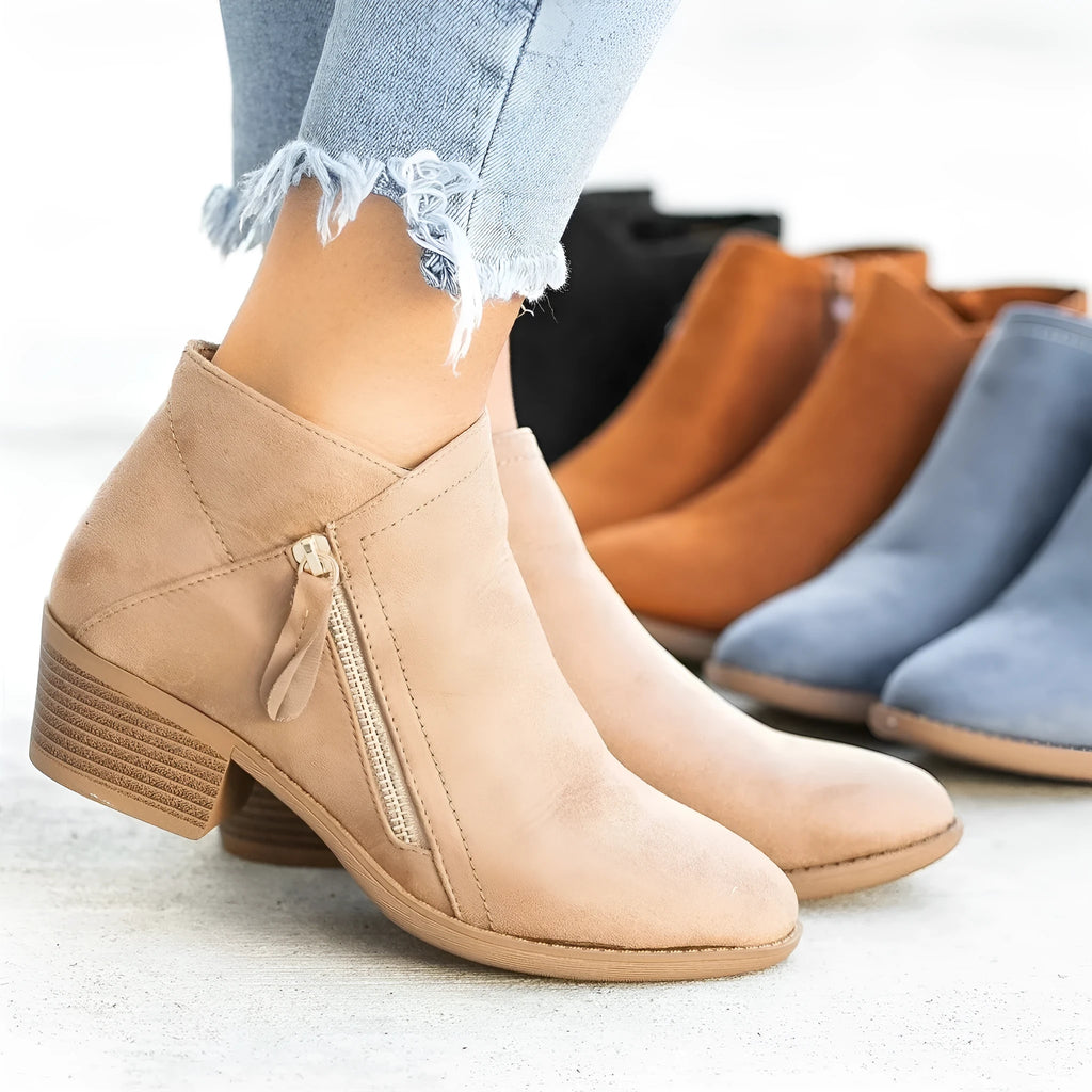 Women's suede ankle boots with a chunky heel and side zip fastening in beige colour.