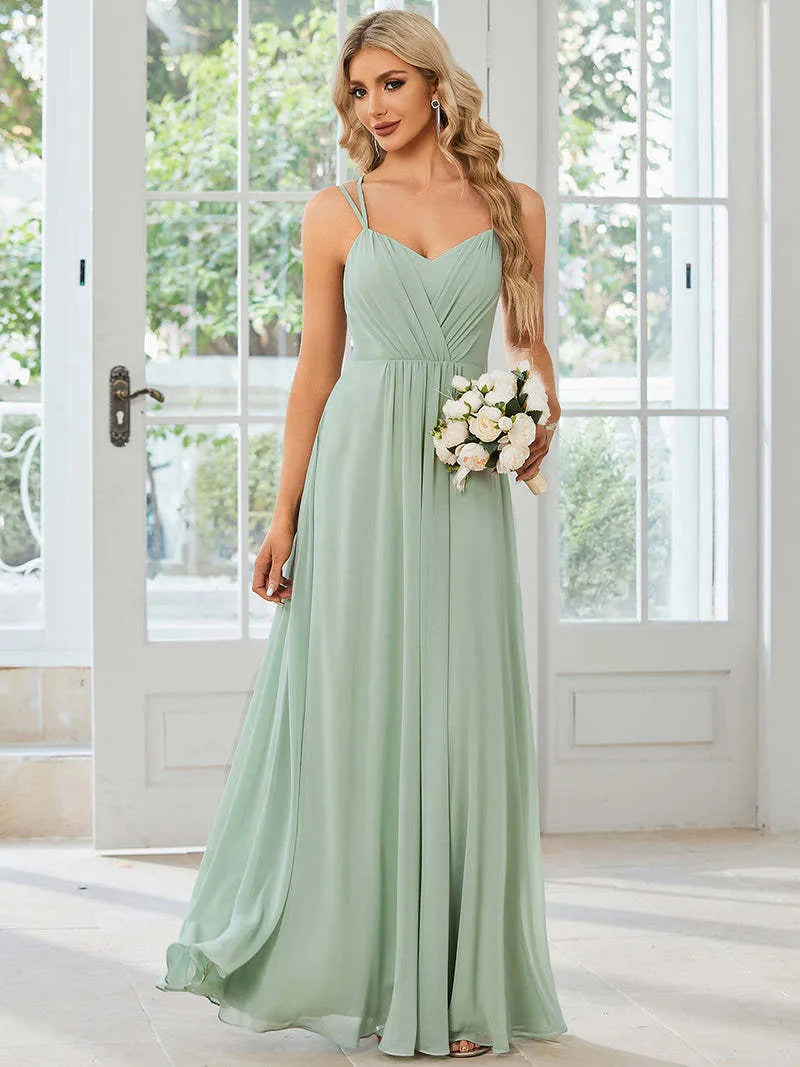 Sleeveless long pleated A-line women's dress in light green polyester fabric, shown on a model.