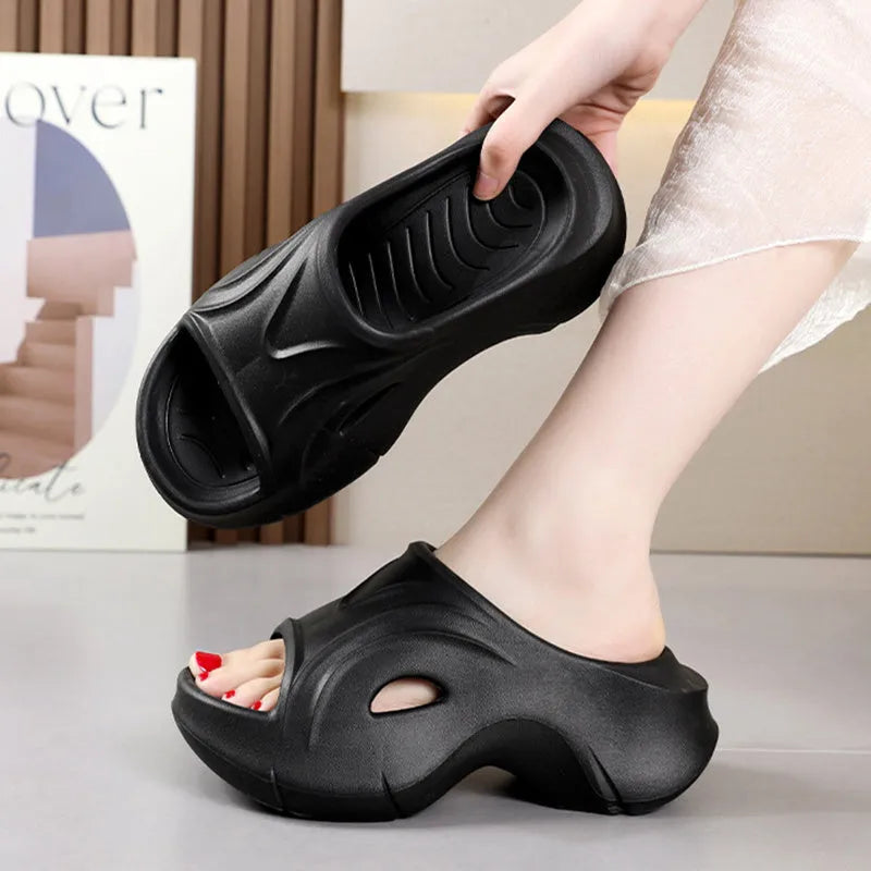 Women's white thick-sole EVA beach slippers with a round toe, shown on a sandy background.
