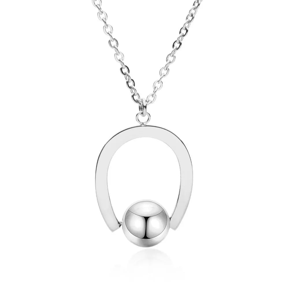 Gold electroplated stainless steel necklace with geometric pendant on an adjustable chain.