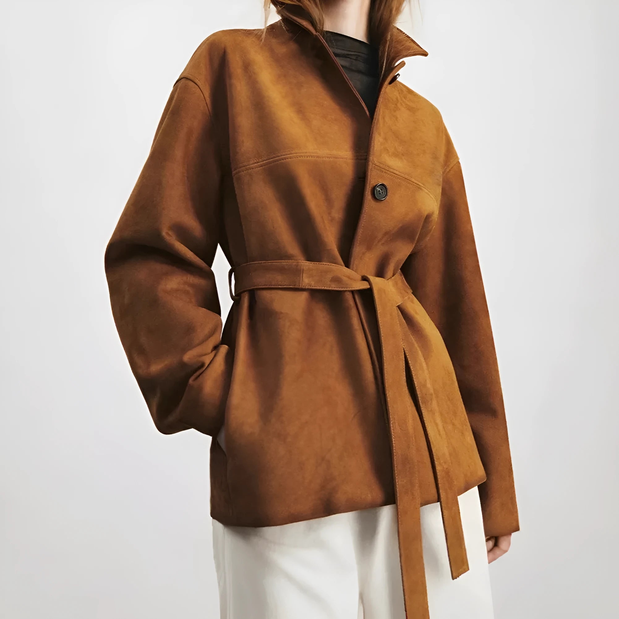 Yellow brown loose fit cashmere coat with a Peter Pan collar and a brown leather belt.