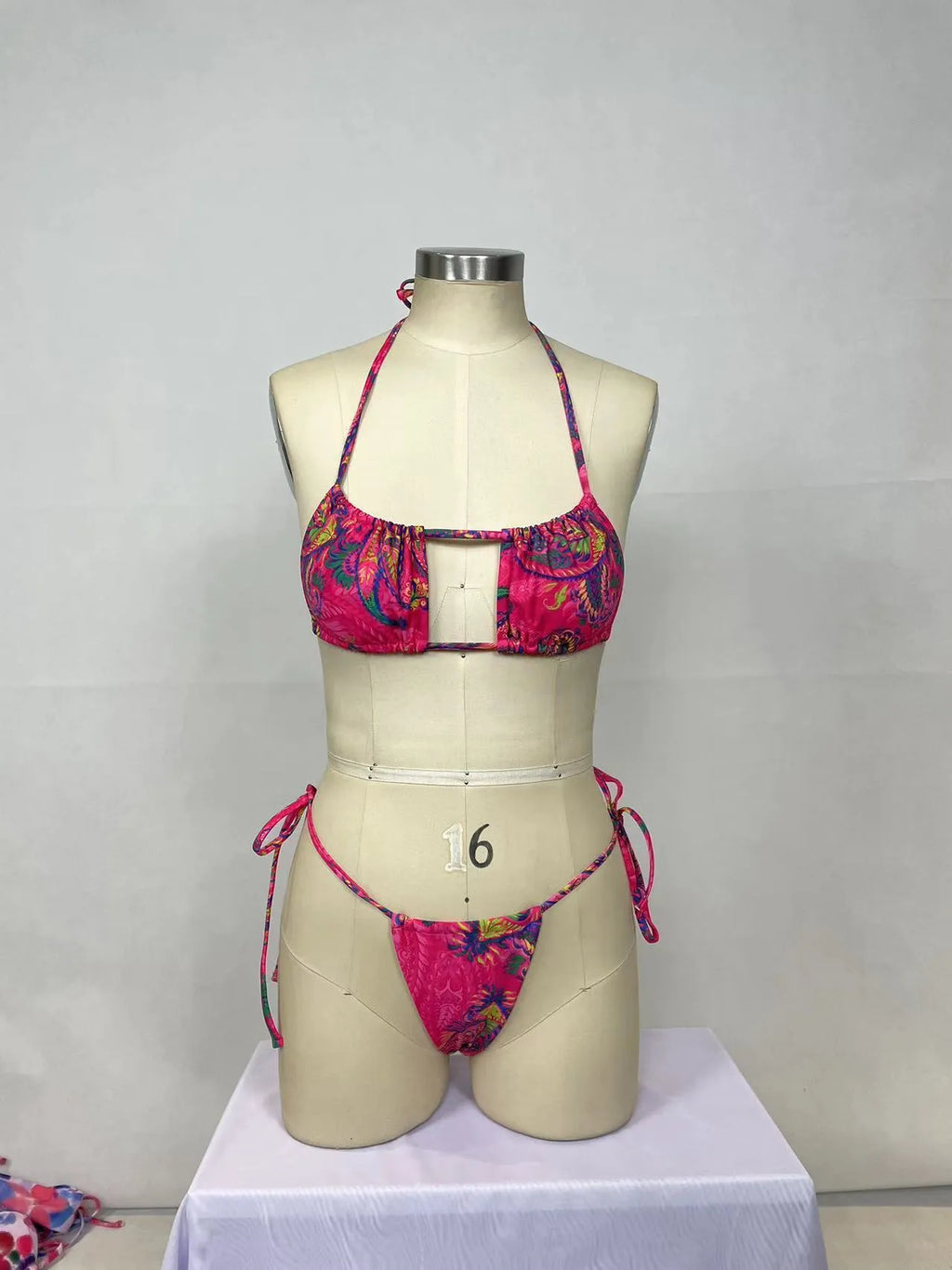 Pink women's bikini two-piece set with printed pattern on nylon fabric.