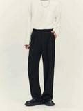 Man wearing black straight-leg business casual trousers with a draping design, made from a polyester blend fabric.
